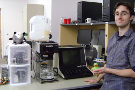 Person posing with coffee maker