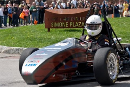 Person driving formula car on track