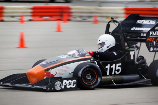 Person driving formula car on track