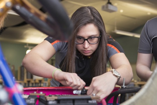Maura Chmielowiec working on car.