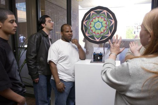 RIT students explaining art piece for people