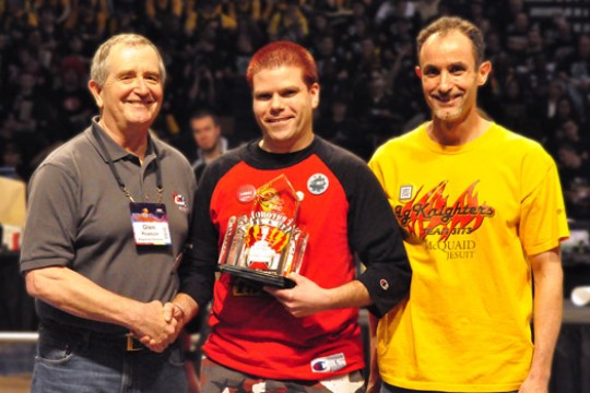 People posing with award