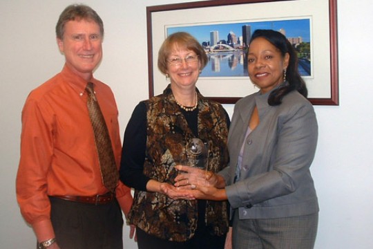 People posing with award
