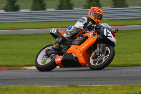Person driving motorcycle on track
