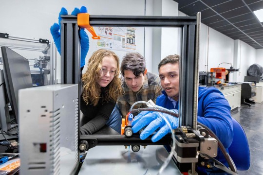 three students create hybrid hydrogels in a lab