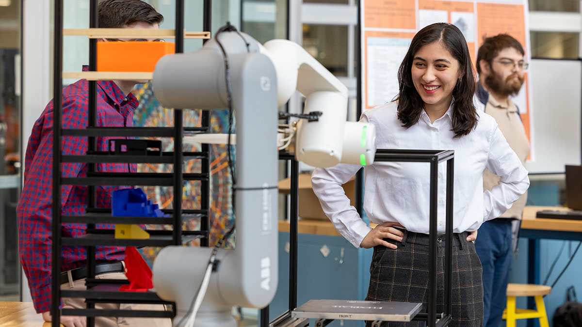 a student working with a 3 D printer in a makerspace.