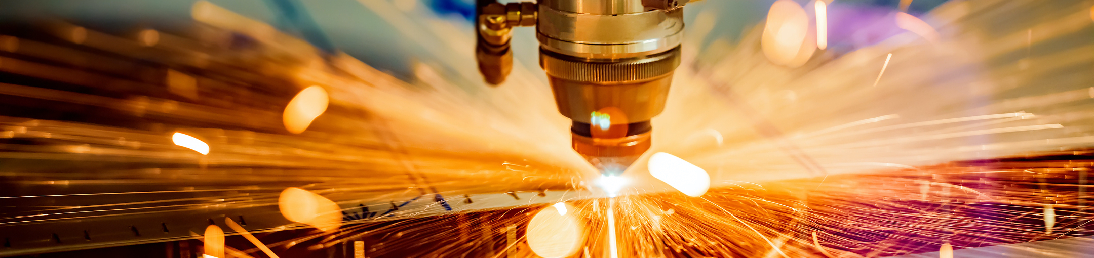 a robot creating sparks by welding or laser cutting.