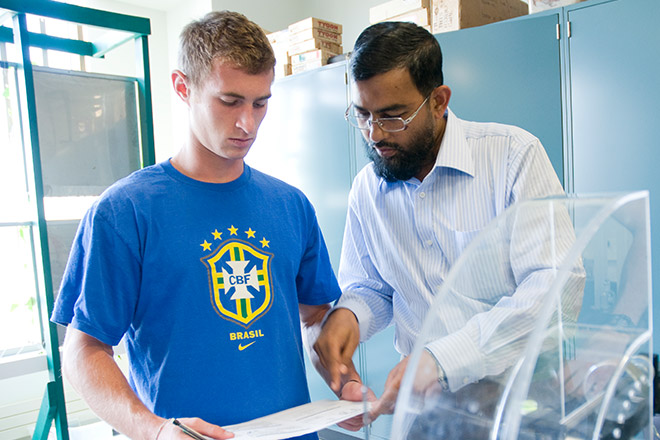 Professor helping a student in a lab