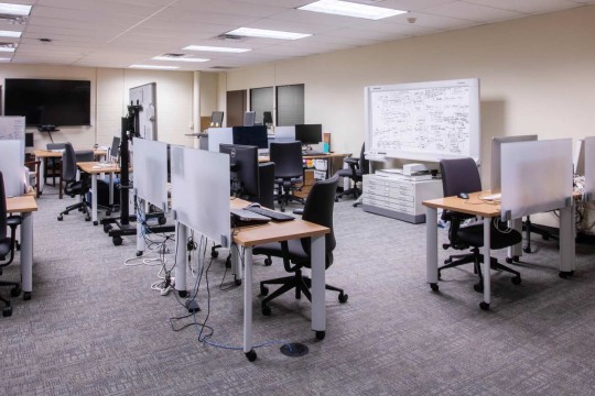 Sectioned off computer lab with different work stations spread out throughout the room