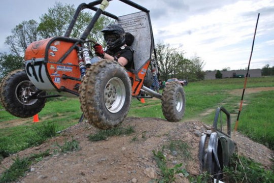 Off road vehicle driving along dirt course