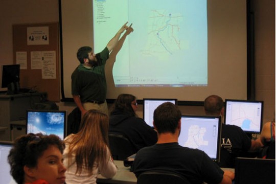 People looking at map in classroom