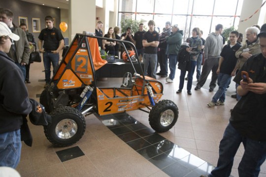 People gathered around BAJA vehicle