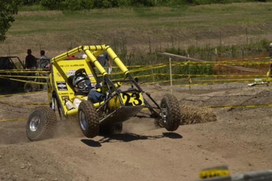 Off road vehicle driving along dirt course