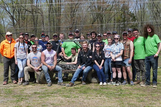 RIT's Baja race team poses for a photo with car.