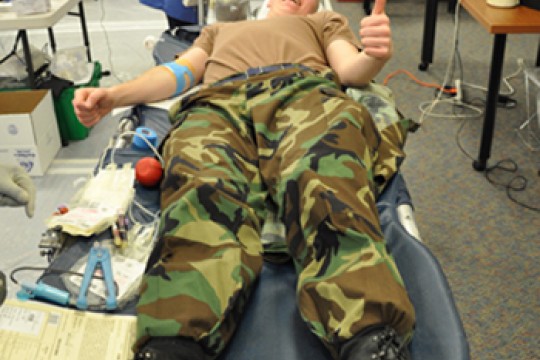 Person giving blood at blood drive
