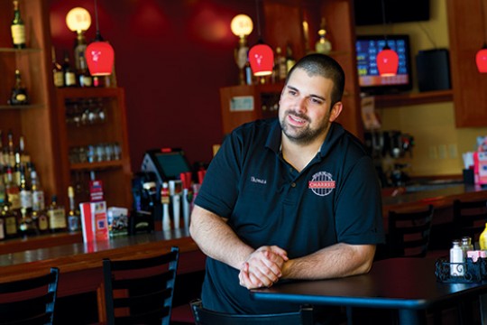 Person posing behind counter