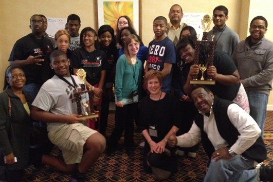 People gathered for picture with award