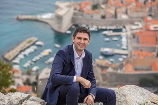 mayor of Dubrovnik posing outside the city.