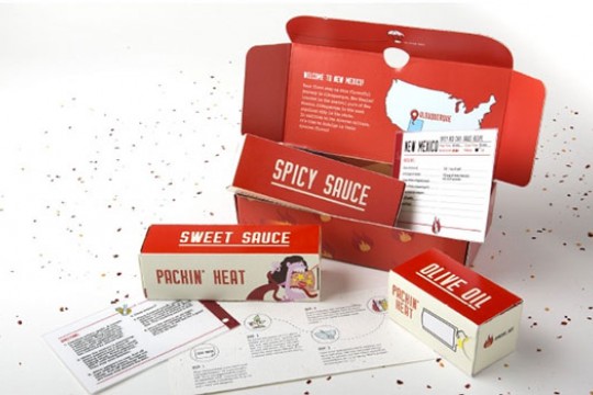 A display of packaging for Packin' Heat Sweet Sauce.