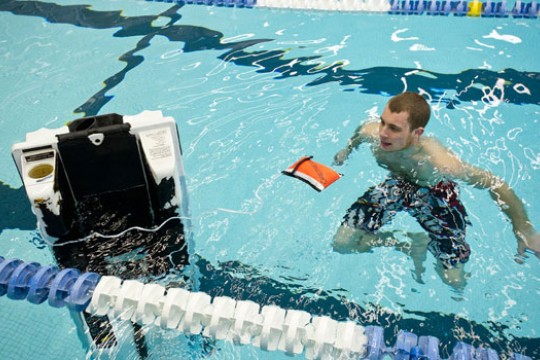 Person swimming with robot 