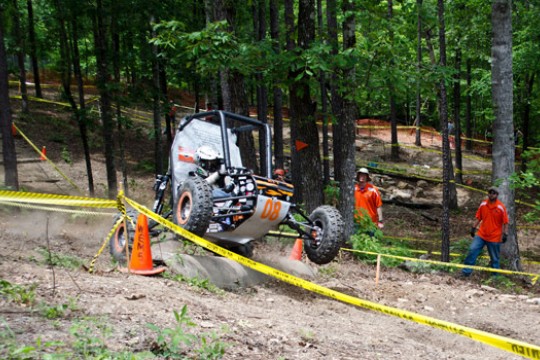 Off road vehicle driving along dirt course