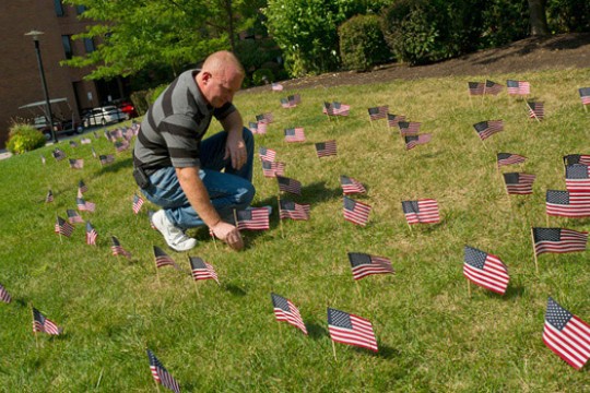 Person laying down flags on gas patch