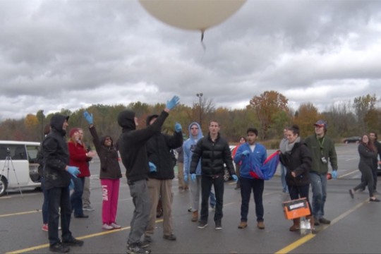 People releasing balloon into the air
