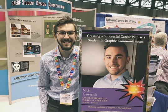 Nick Gawreluk poses with the promotional poster for his talk.