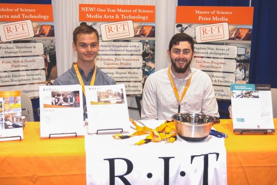 Photo by Bruce Myers: School of Media Sciences students Alexander Greenhalgh, left, and Tommy Hodgson work RIT's booth at Print 17.