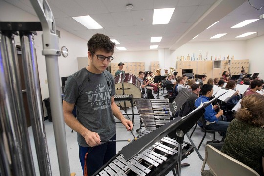 Student plays xylophone in orchestra.