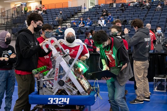 six students working on a robot.