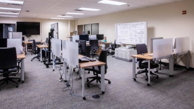 Sectioned off computer lab with different work stations spread out throughout the room