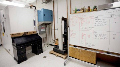 A movable whiteboard next to a large piece of equipment