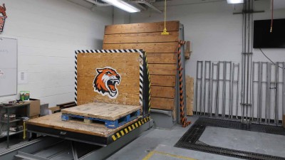 Lab with a wooden block with an RIT tiger face on it