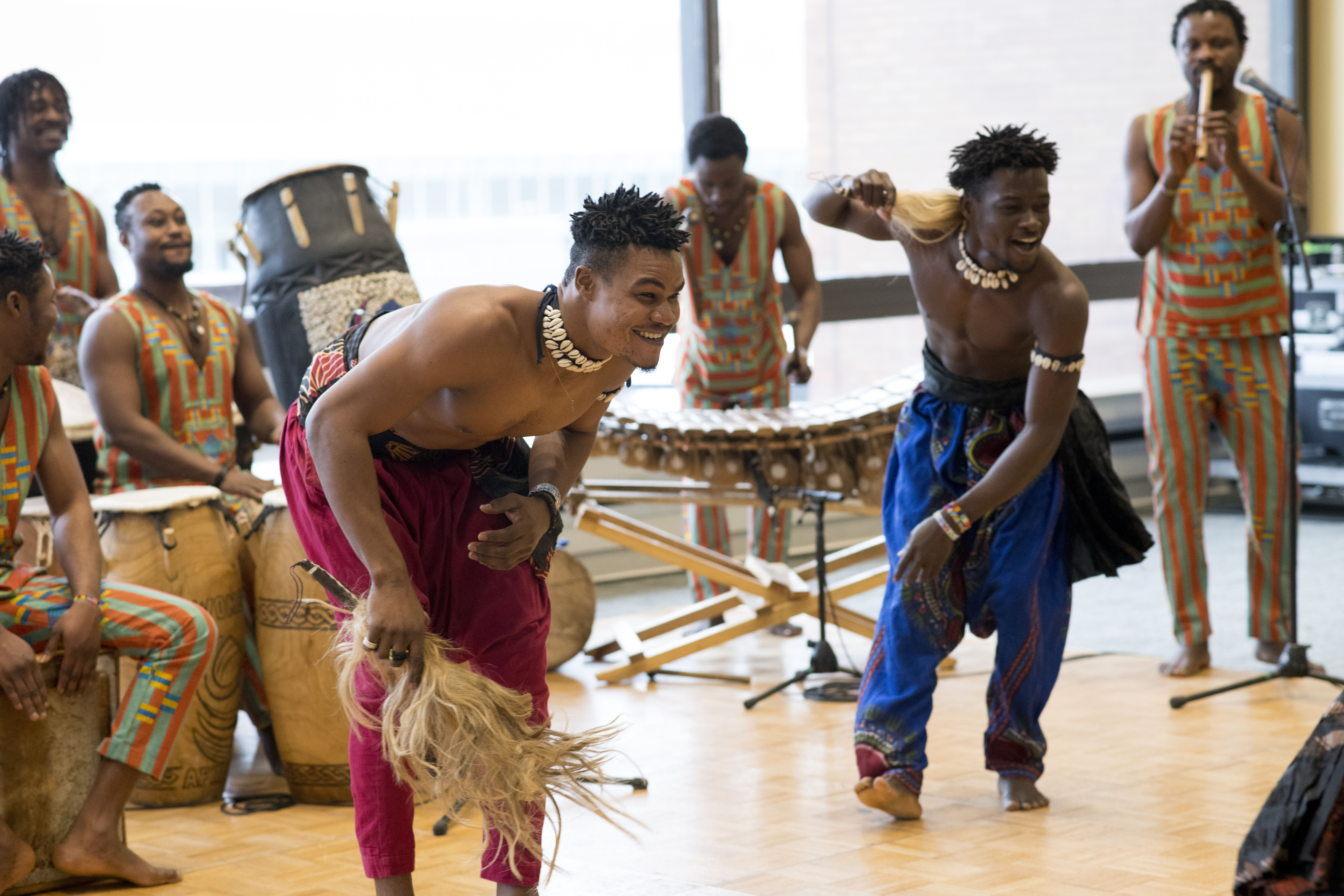men drumming and dancing