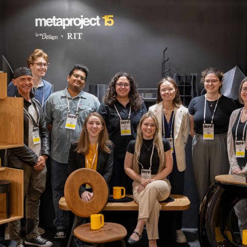 A group of students next to designs they made for the 2025 International Contemporary Furniture Fair.