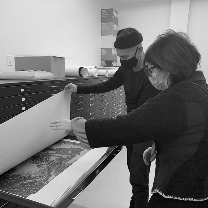 Two people look at archived artifacts.
