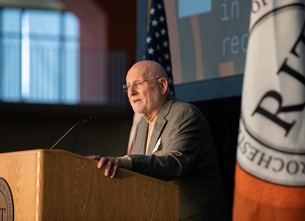 Roger Remington speaks at a lectern.