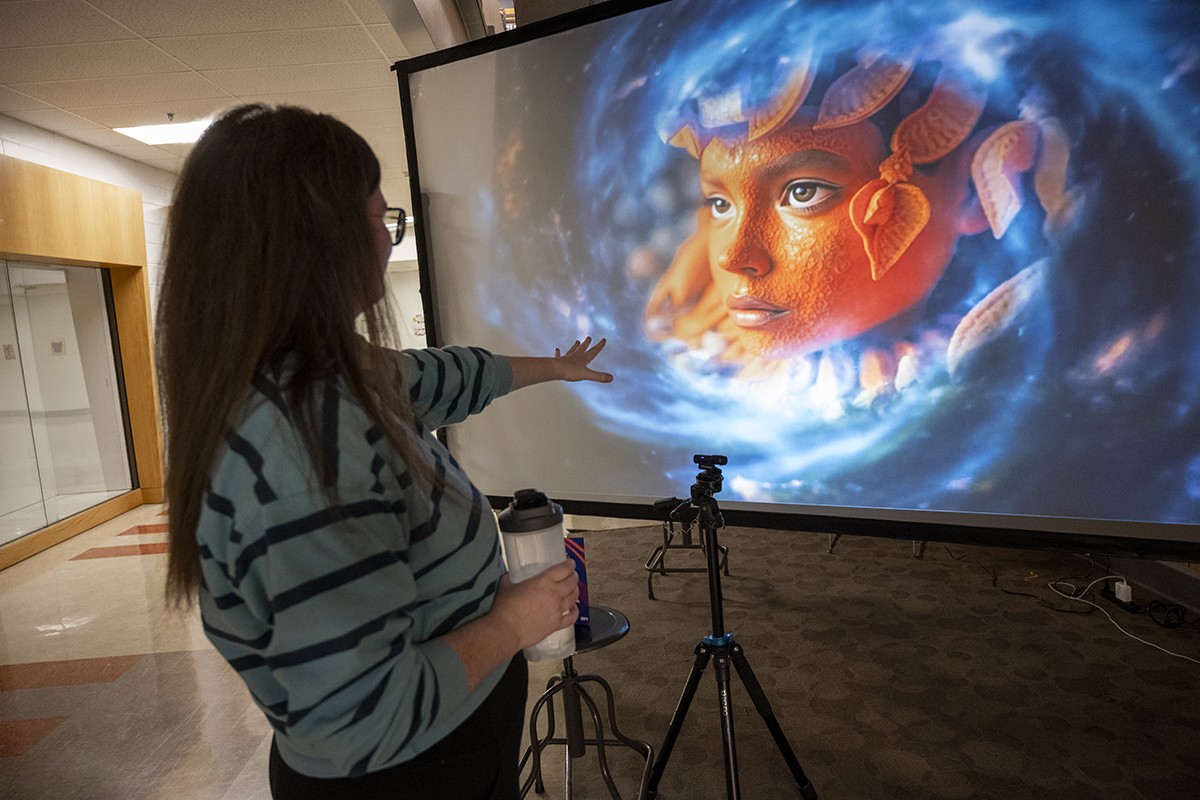 Someone looks at a screen with an AI-generated image.