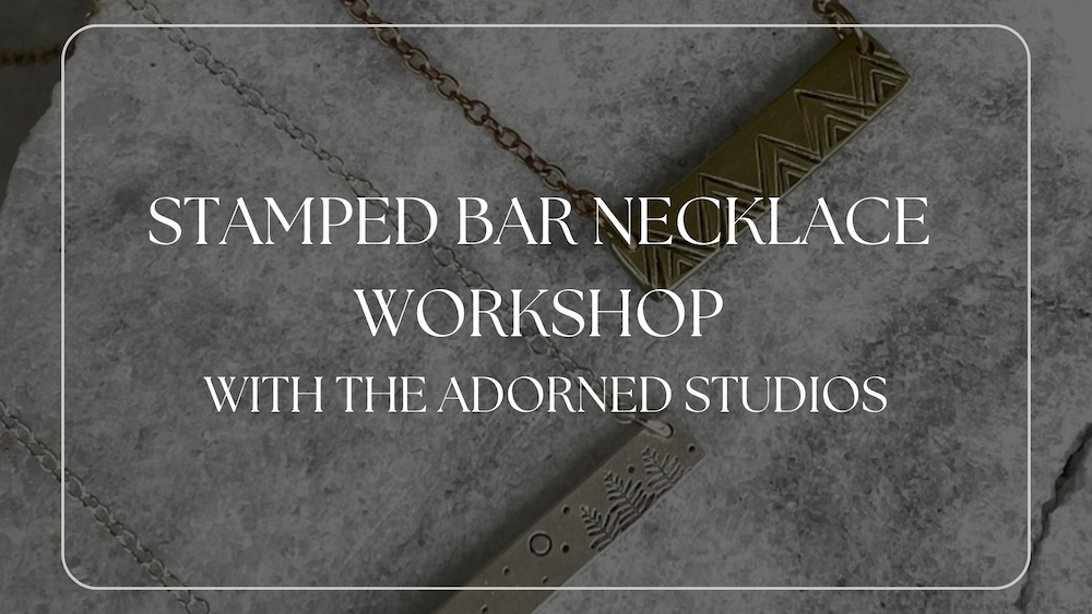 necklace on a concrete back ground with white rectangle around it. says stamped bar workshop with adorned studios