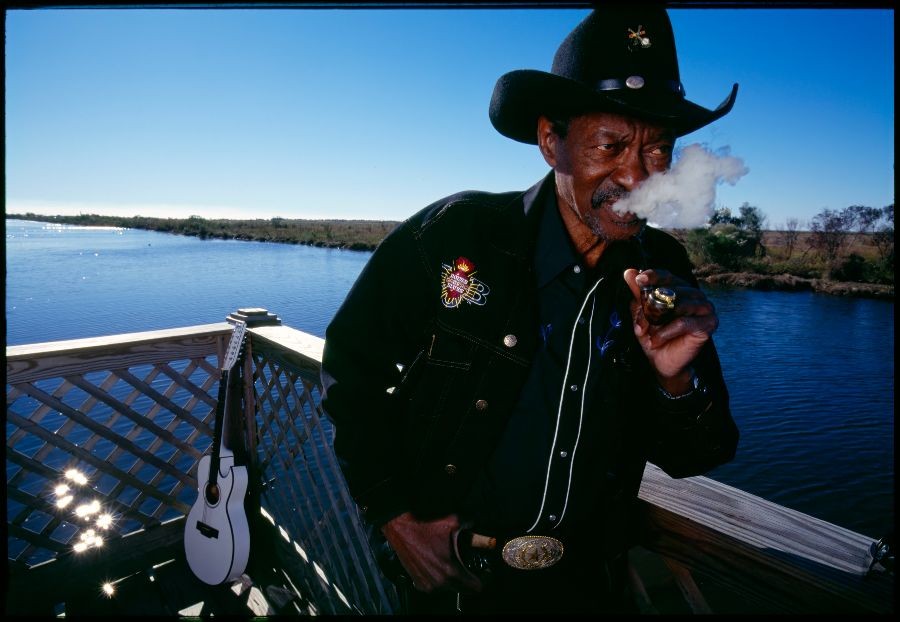 A portrait of Clarence Brown smoking a cigar.