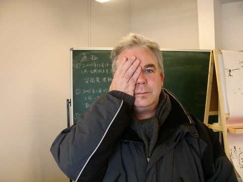 Robert Appleton holding one of his hands over an eye.