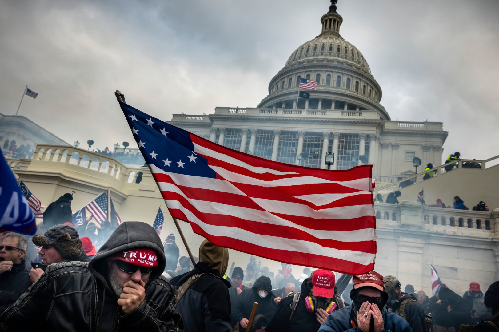 Photo of those involved in the January 2021 insurrection, with the Capitol building in the background.