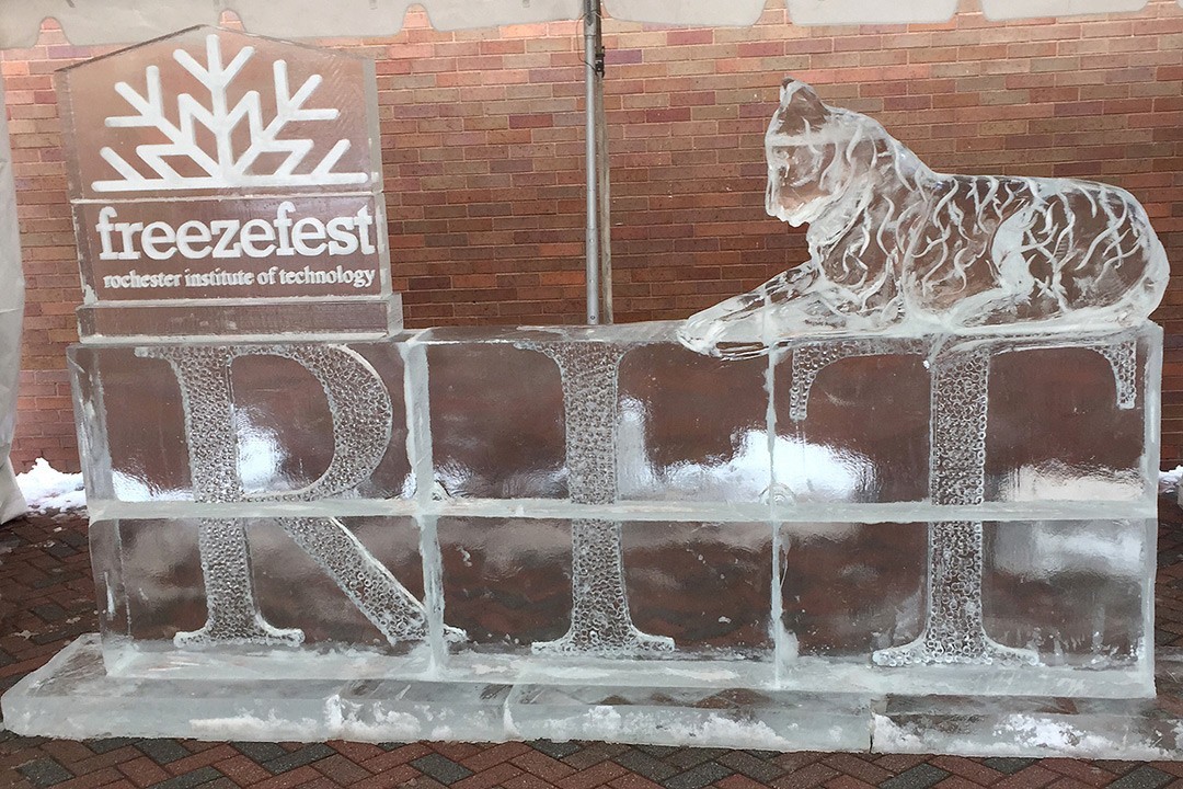 photo of an ice sculpture that includes "RIT" the FreezeFest logo, and a tiger