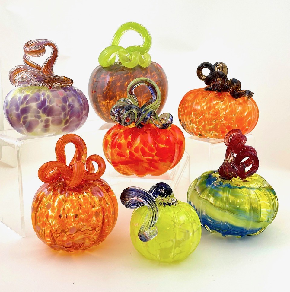 A group of colorful glass pumpkins.