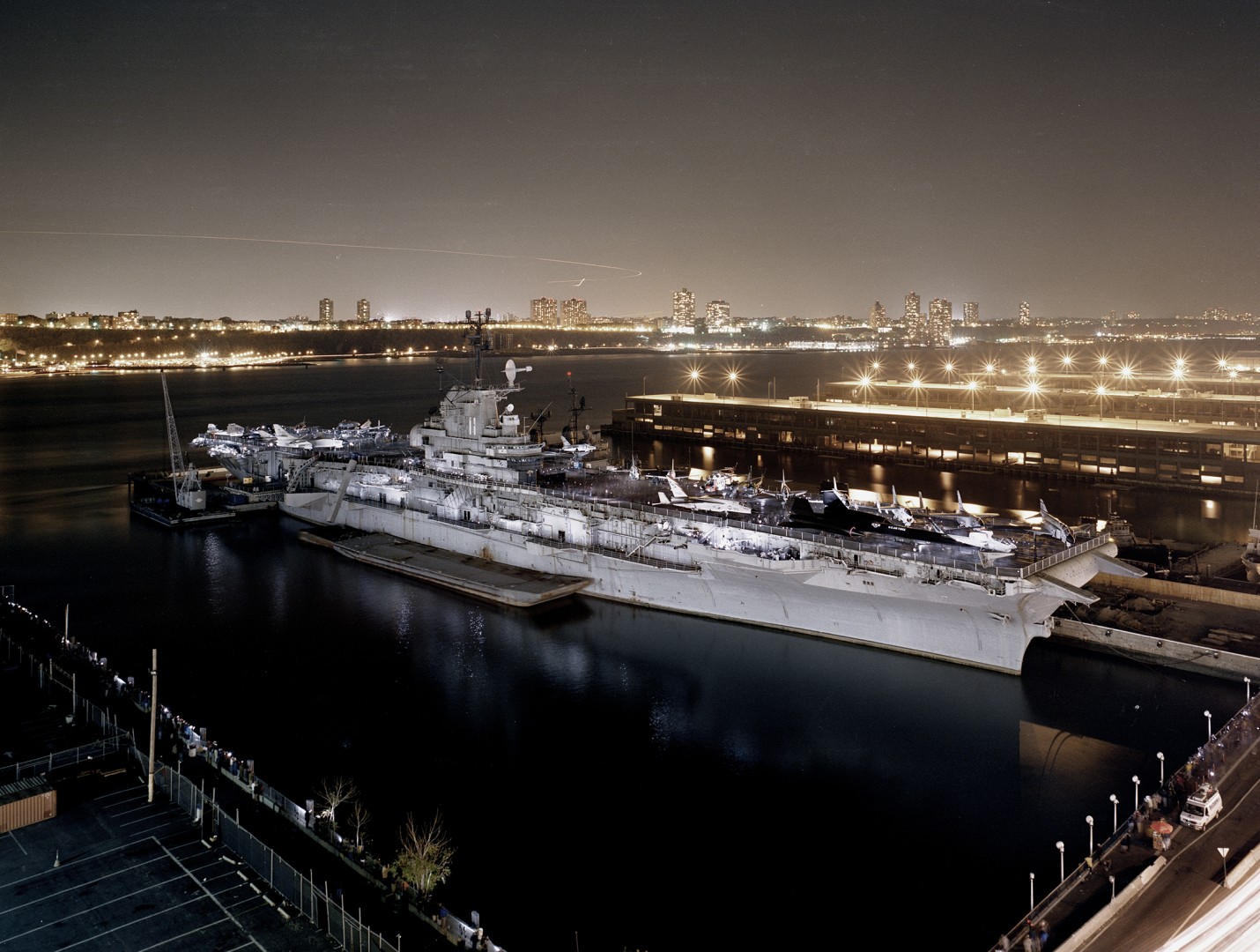A nighttime photo of the Intrepid Sea, Air, and Space Museum.