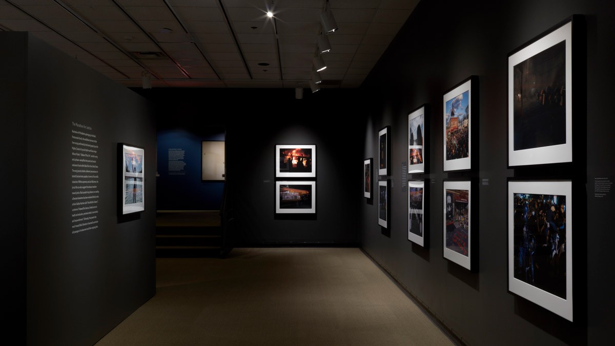 photo exhibit with framed photos hanging on the walls.