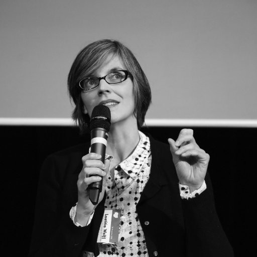 Laetitia Wolff speaking into a microphone.