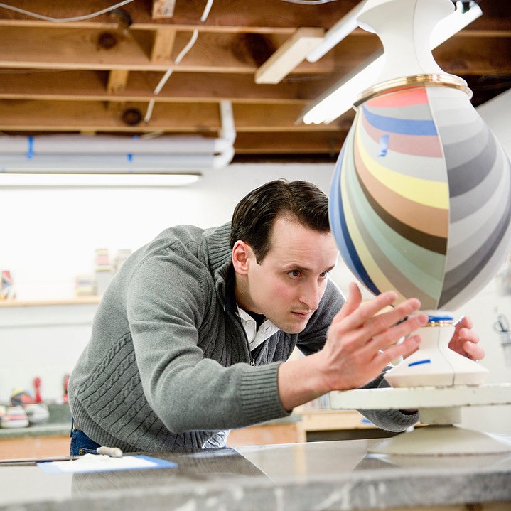 Peter Pincus looks at a colorful vase.