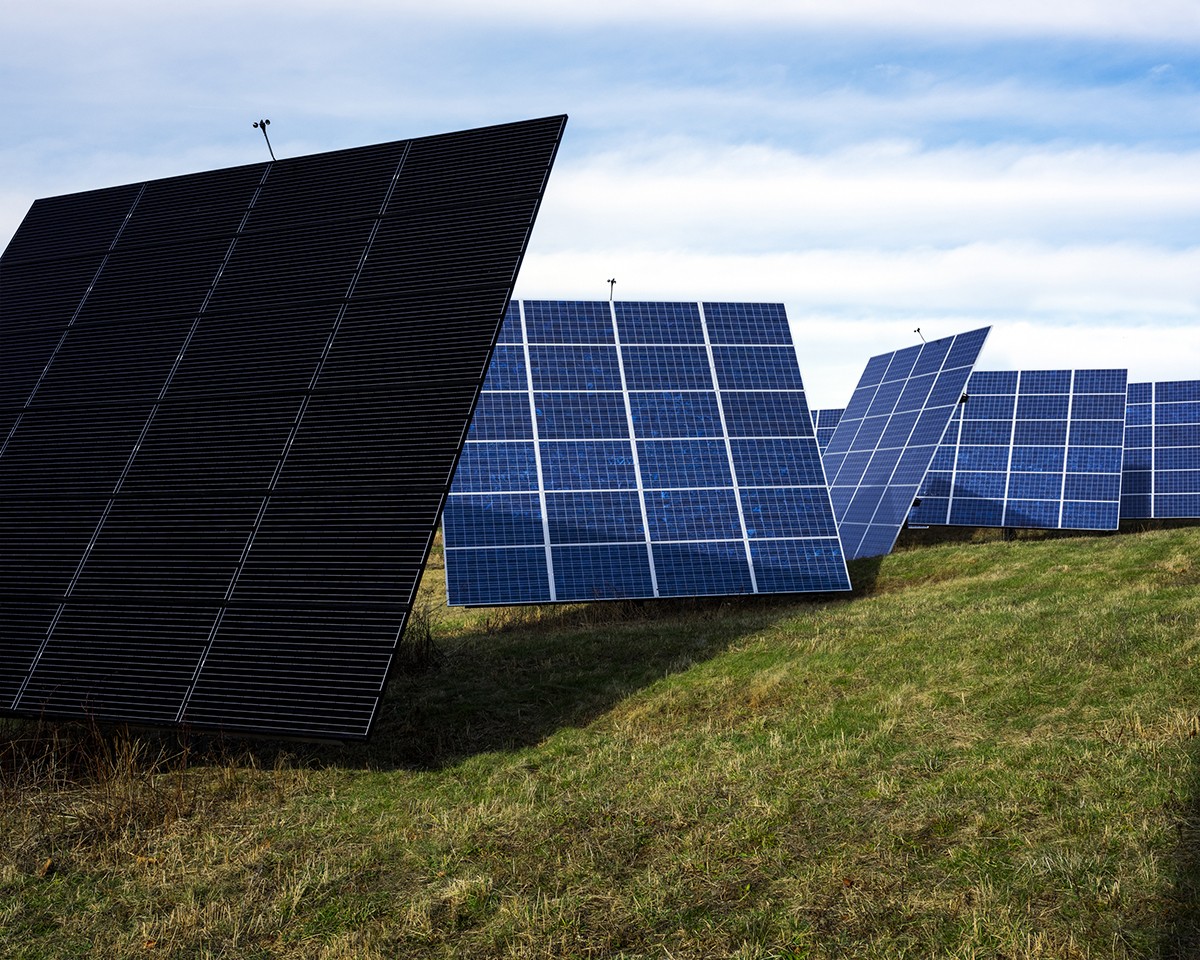 A series of large solar panels on grass.